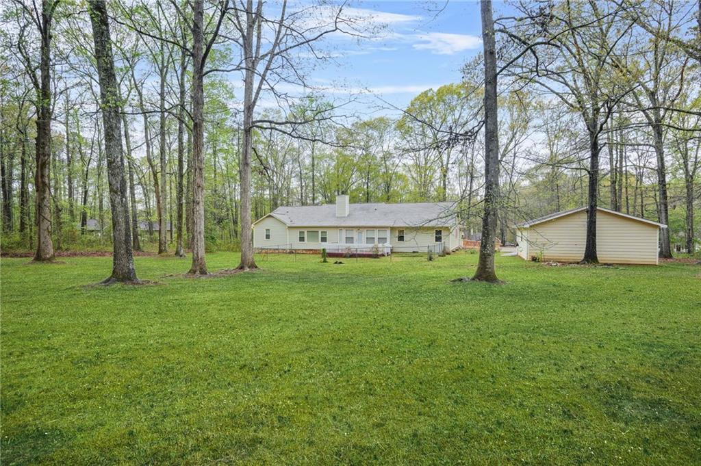 125 Bridget Drive Hampton, GA 30228 - Photo 26 of 32 a view of a house with backyard and a tree