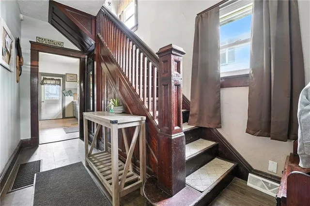 a view of entryway and hall with wooden floor