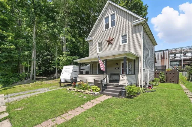 a front view of a house with a yard table and chairs