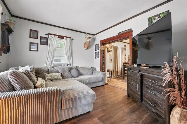 a living room with furniture a ceiling fan and a window
