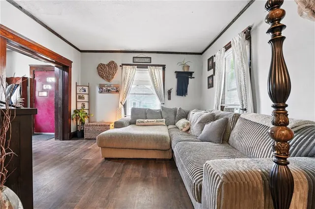 a living room with furniture a window and a chandelier