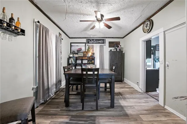 a view of a a dining room with furniture window and wooden floor