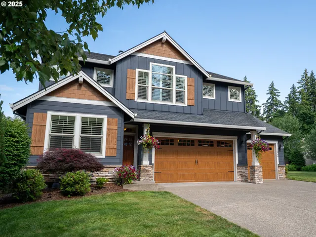 a front view of a house with a garden and yard