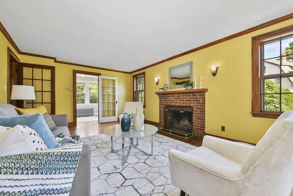 11 Southbourne Road Boston, MA 02130 - Photo 3 of 26 a living room with furniture a fireplace and a floor to ceiling window