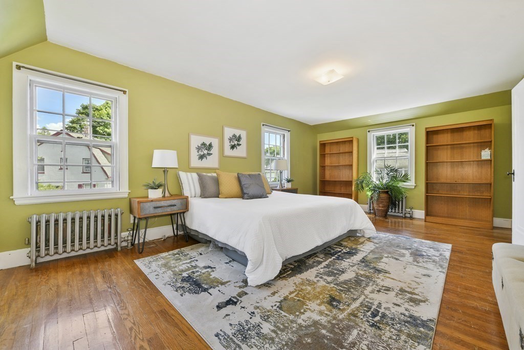 11 Southbourne Road Boston, MA 02130 - Photo 10 of 26 a bedroom with a bed a dresser and wooden floor