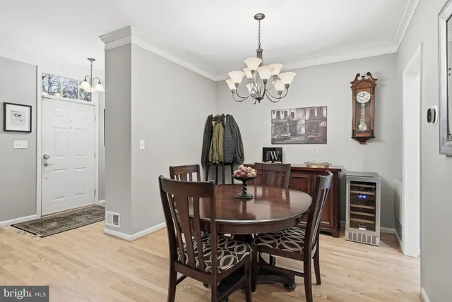 a view of a dining room with furniture and chandelier