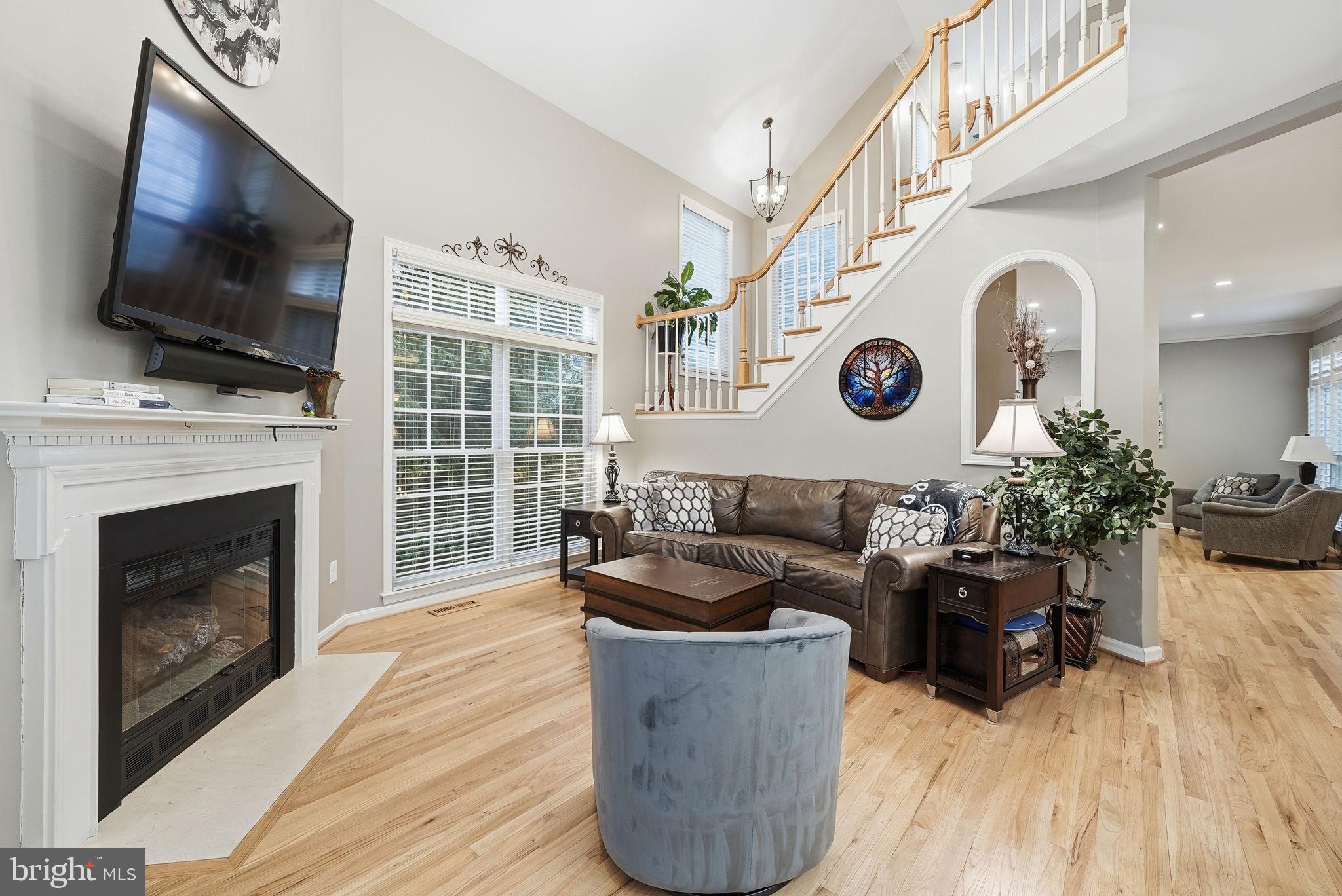 11411 Hollow Timber Court Reston, VA 20194 - Photo 12 of 46 a living room with furniture a flat screen tv and a fireplace