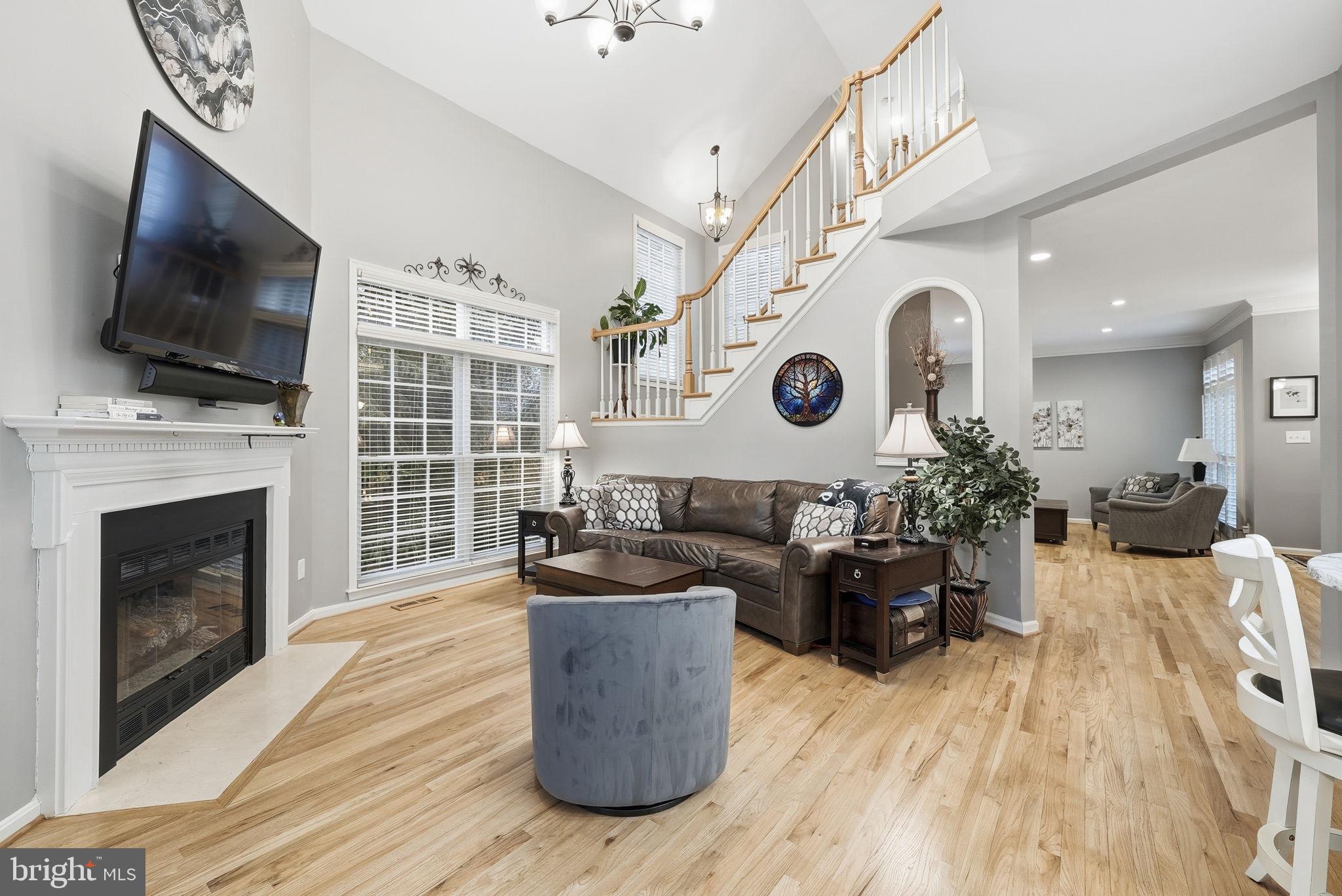 11411 Hollow Timber Court Reston, VA 20194 - Photo 14 of 46 a living room with furniture a flat screen tv and a fireplace