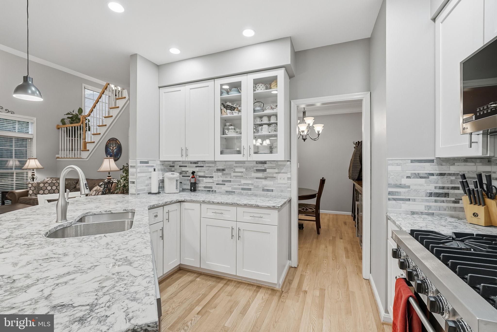 11411 Hollow Timber Court Reston, VA 20194 - Photo 17 of 46 a kitchen with stainless steel appliances granite countertop a sink stove and refrigerator