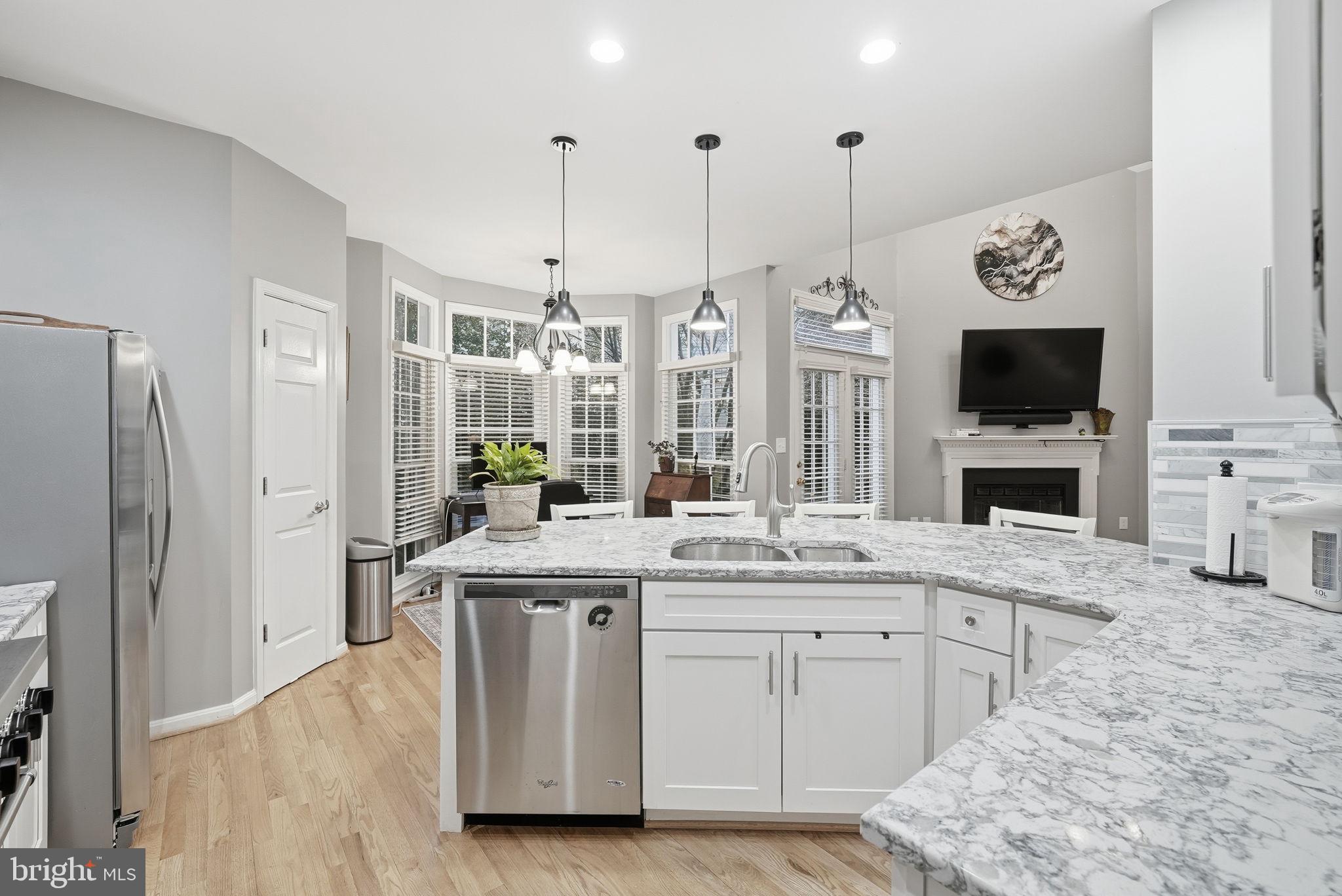 11411 Hollow Timber Court Reston, VA 20194 - Photo 18 of 46 a kitchen with stainless steel appliances granite countertop a stove a sink and a refrigerator