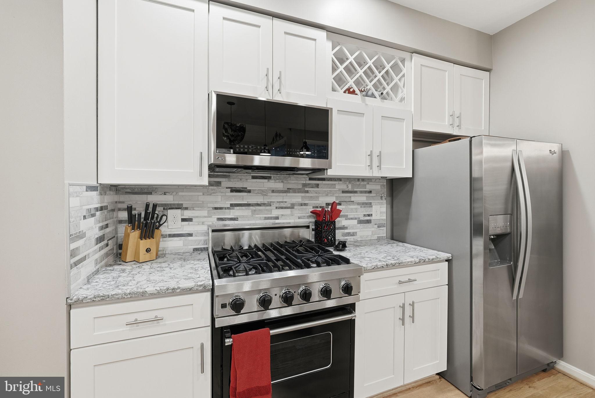 11411 Hollow Timber Court Reston, VA 20194 - Photo 19 of 46 a kitchen with stainless steel appliances granite countertop a refrigerator stove and microwave