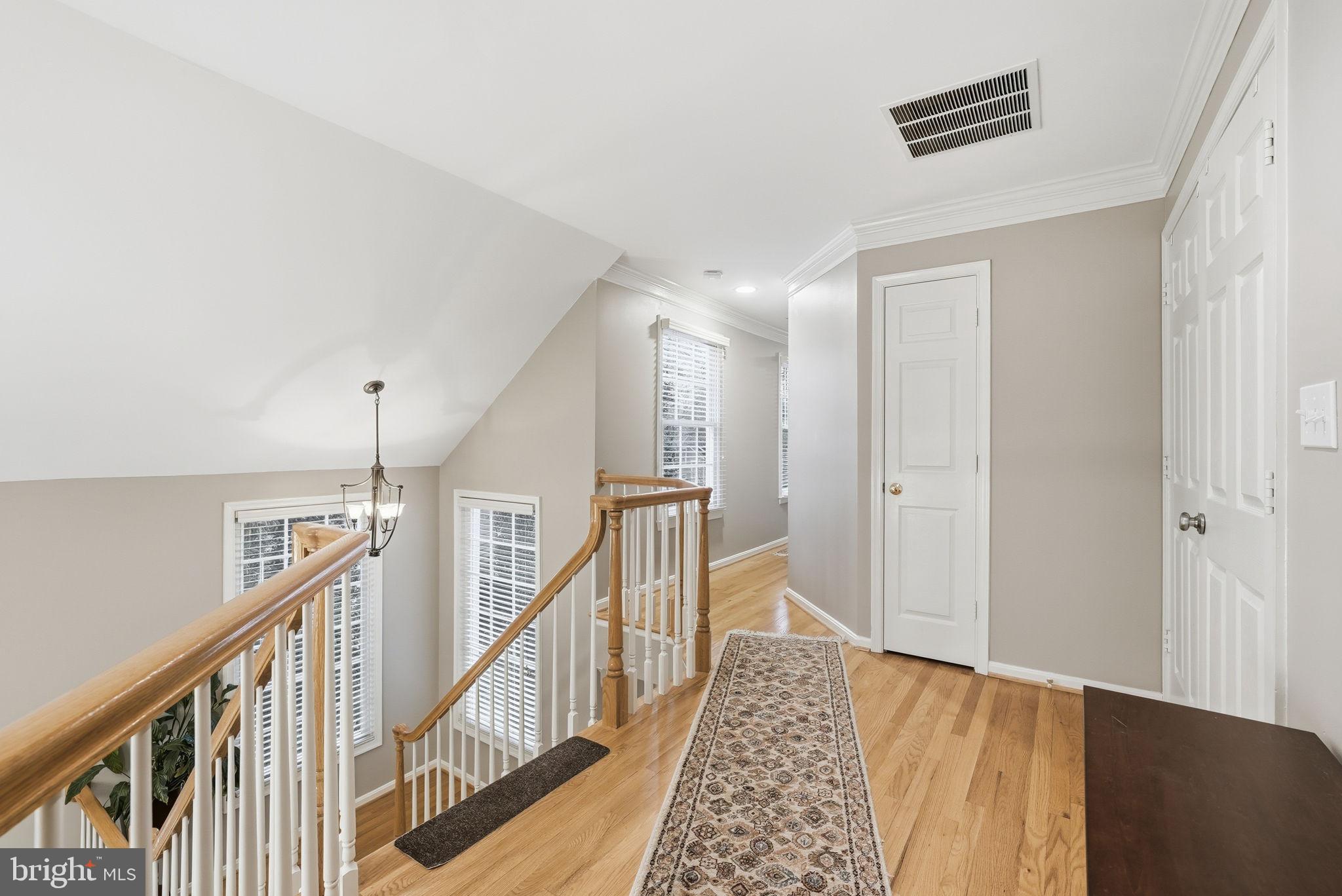 11411 Hollow Timber Court Reston, VA 20194 - Photo 22 of 46 a view of a hallway with wooden floor and staircase