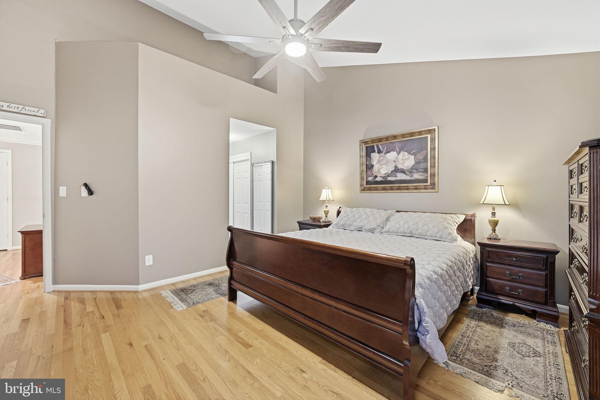 11411 Hollow Timber Court Reston, VA 20194 - Photo 25 of 46 a spacious bedroom with a bed and a chandelier