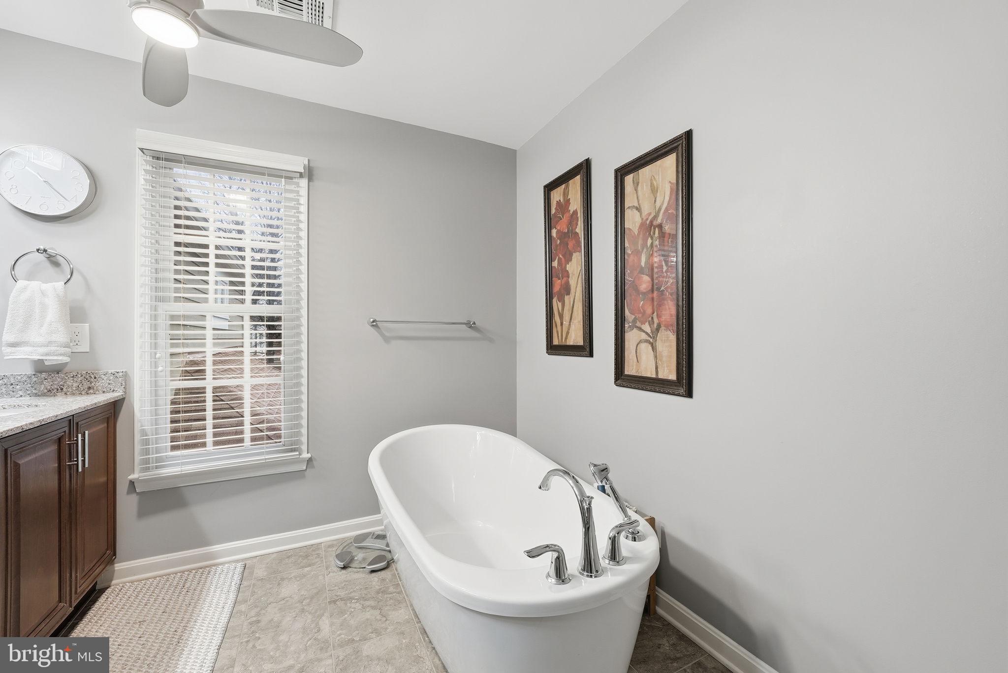 11411 Hollow Timber Court Reston, VA 20194 - Photo 28 of 46 a bathroom with a granite countertop sink and a window