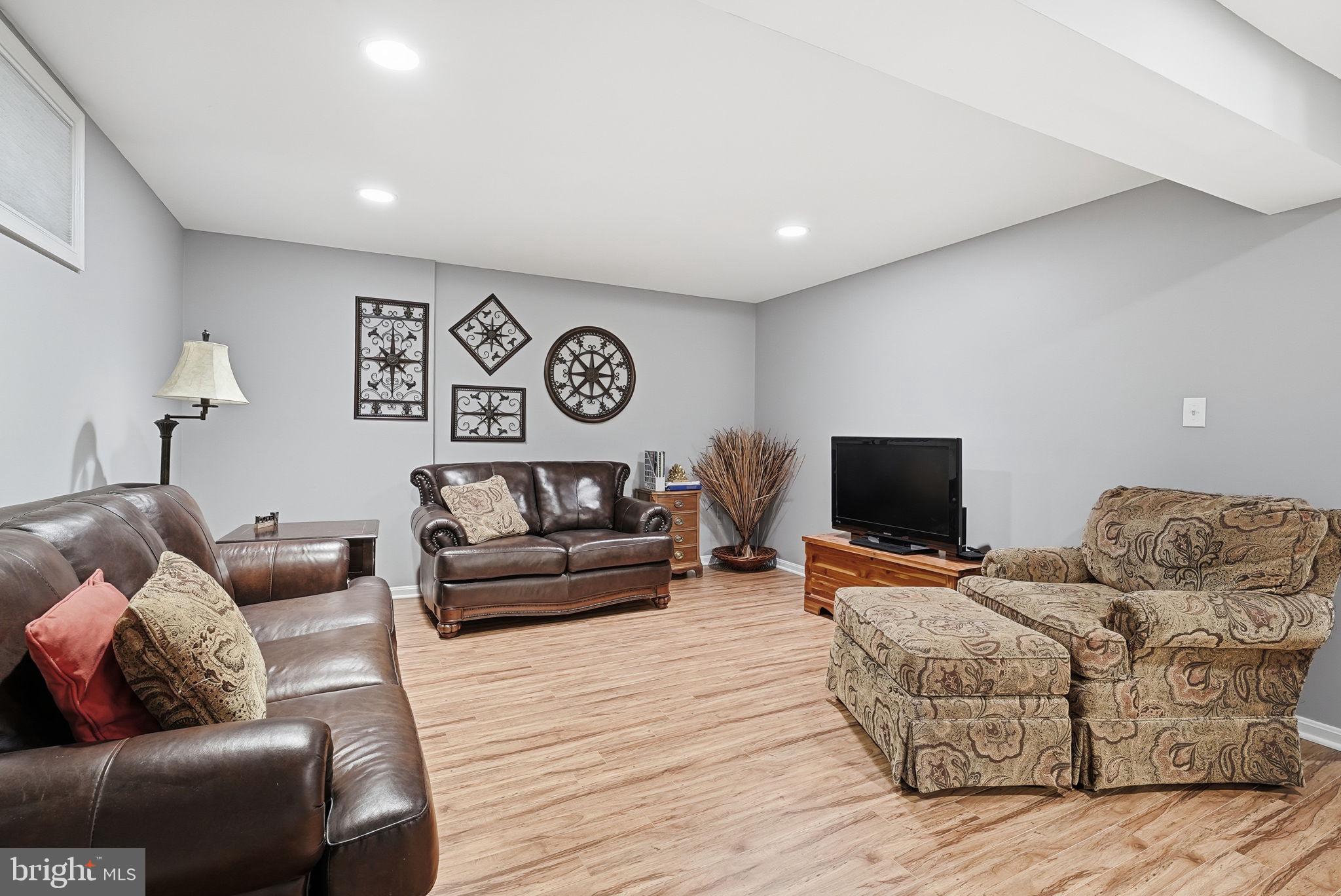 11411 Hollow Timber Court Reston, VA 20194 - Photo 35 of 46 a living room with furniture and a flat screen tv