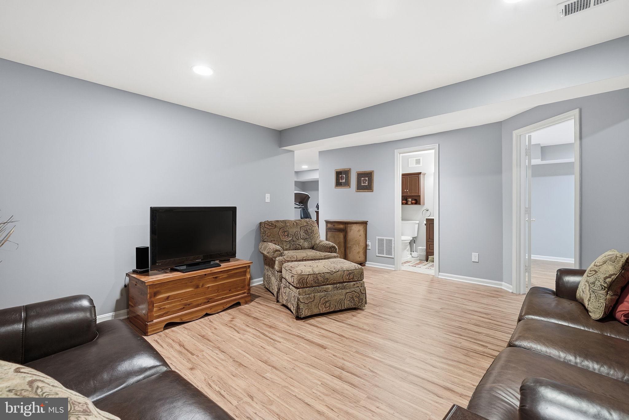 11411 Hollow Timber Court Reston, VA 20194 - Photo 37 of 46 a living room with furniture and a flat screen tv
