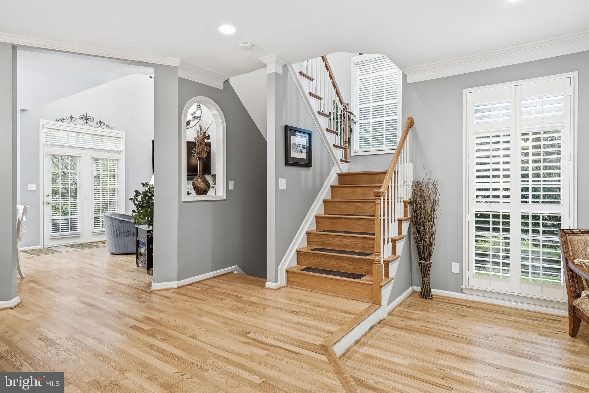 11411 Hollow Timber Court Reston, VA 20194 - Photo 5 of 46 a view of a livingroom with wooden floor and stairs