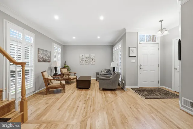 a spacious bedroom with a bed and wooden floor
