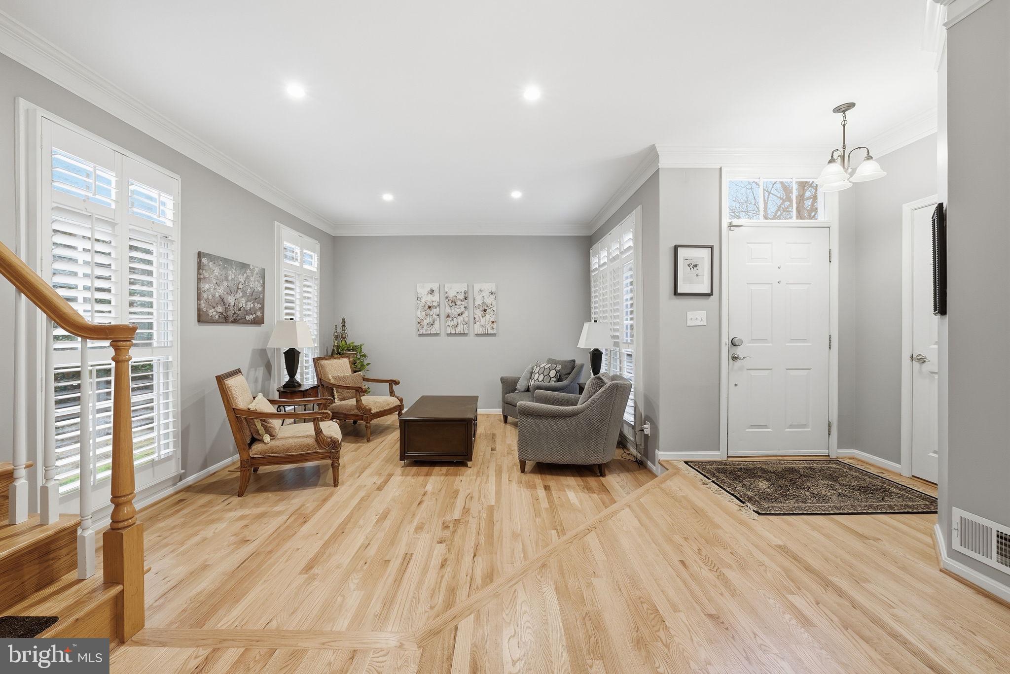 11411 Hollow Timber Court Reston, VA 20194 - Photo 8 of 46 a spacious bedroom with a bed and wooden floor