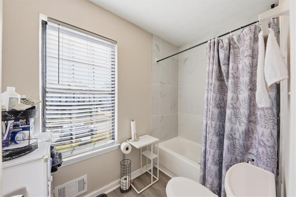 3682 Stephanie Court Powder Springs, GA 30127 - Photo 16 of 23 a bathroom with a sink toilet and shower