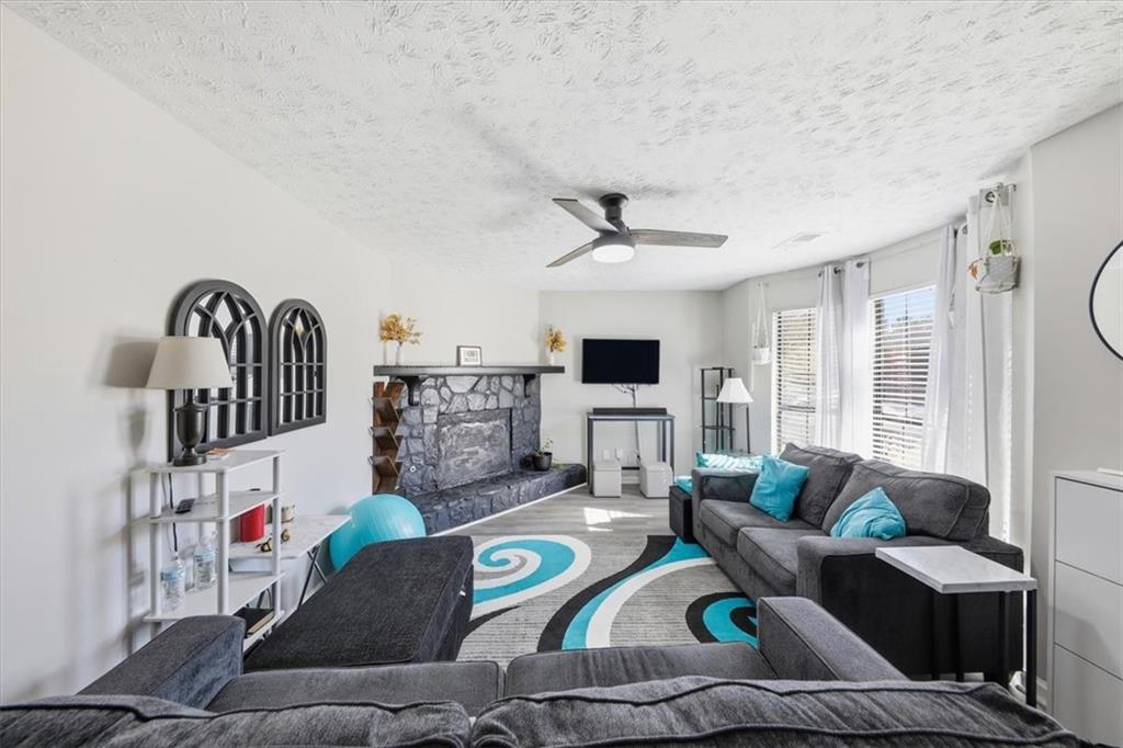 3682 Stephanie Court Powder Springs, GA 30127 - Photo 5 of 23 a living room with furniture and a flat screen tv