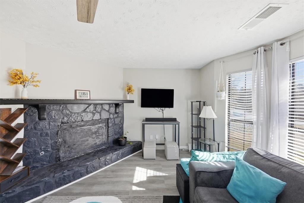 3682 Stephanie Court Powder Springs, GA 30127 - Photo 7 of 23 a living room with furniture a flat screen tv and a window