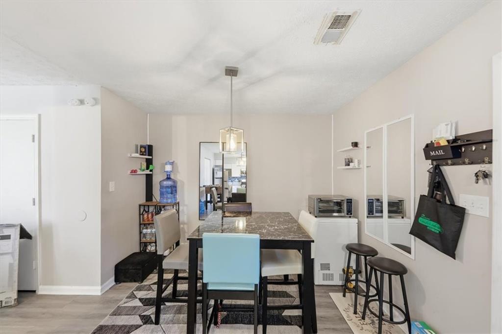 3682 Stephanie Court Powder Springs, GA 30127 - Photo 8 of 23 a view of a dining room with furniture and wooden floor