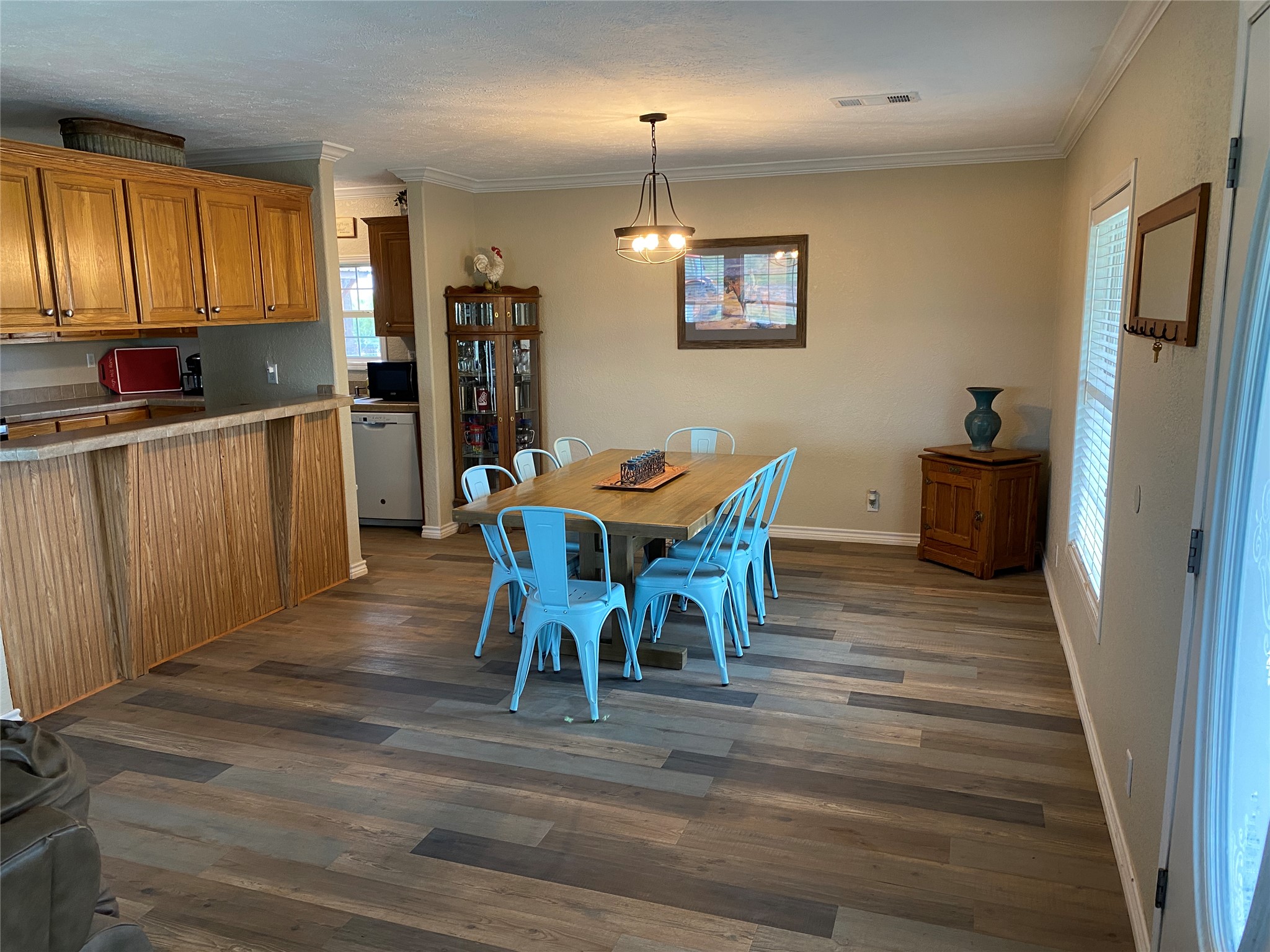 906 C R 235 Old Glory, TX 79540 - Photo 23 of 40 Dining area with dark wood-style floors, crown molding, and baseboards