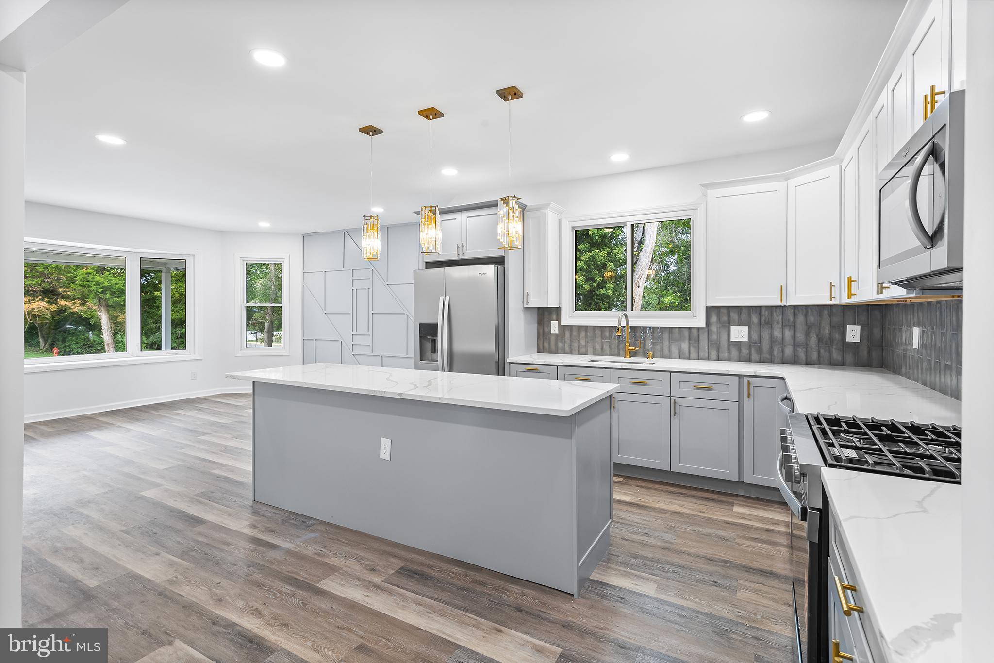 97 Erial Road Clementon, NJ 08021 - Photo 14 of 48 a large kitchen with stainless steel appliances granite countertop a stove a sink dishwasher a refrigerator and white cabinets with wooden floor