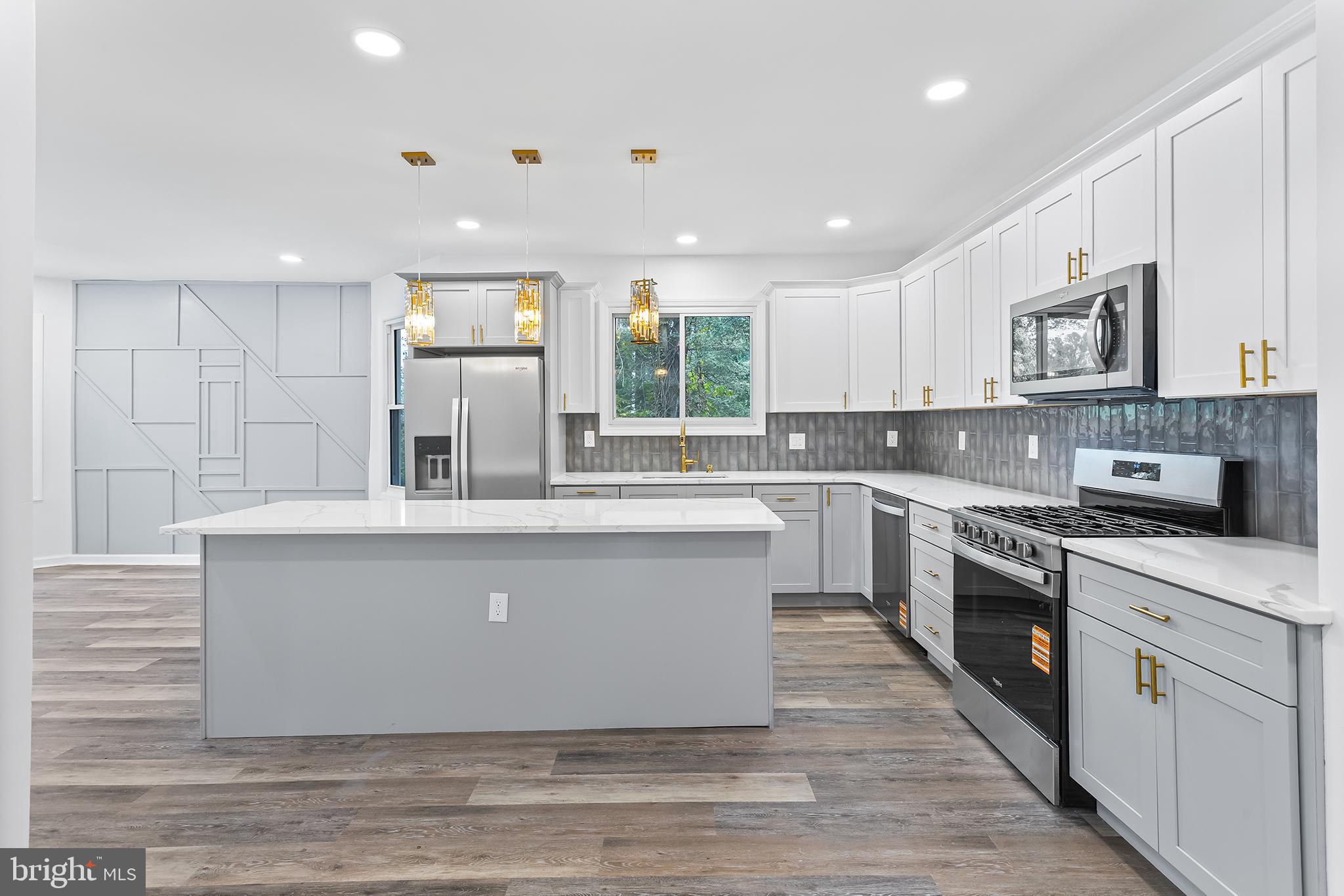 97 Erial Road Clementon, NJ 08021 - Photo 15 of 48 a large kitchen with stainless steel appliances granite countertop a stove a sink dishwasher and a microwave oven with large wooden cabinets