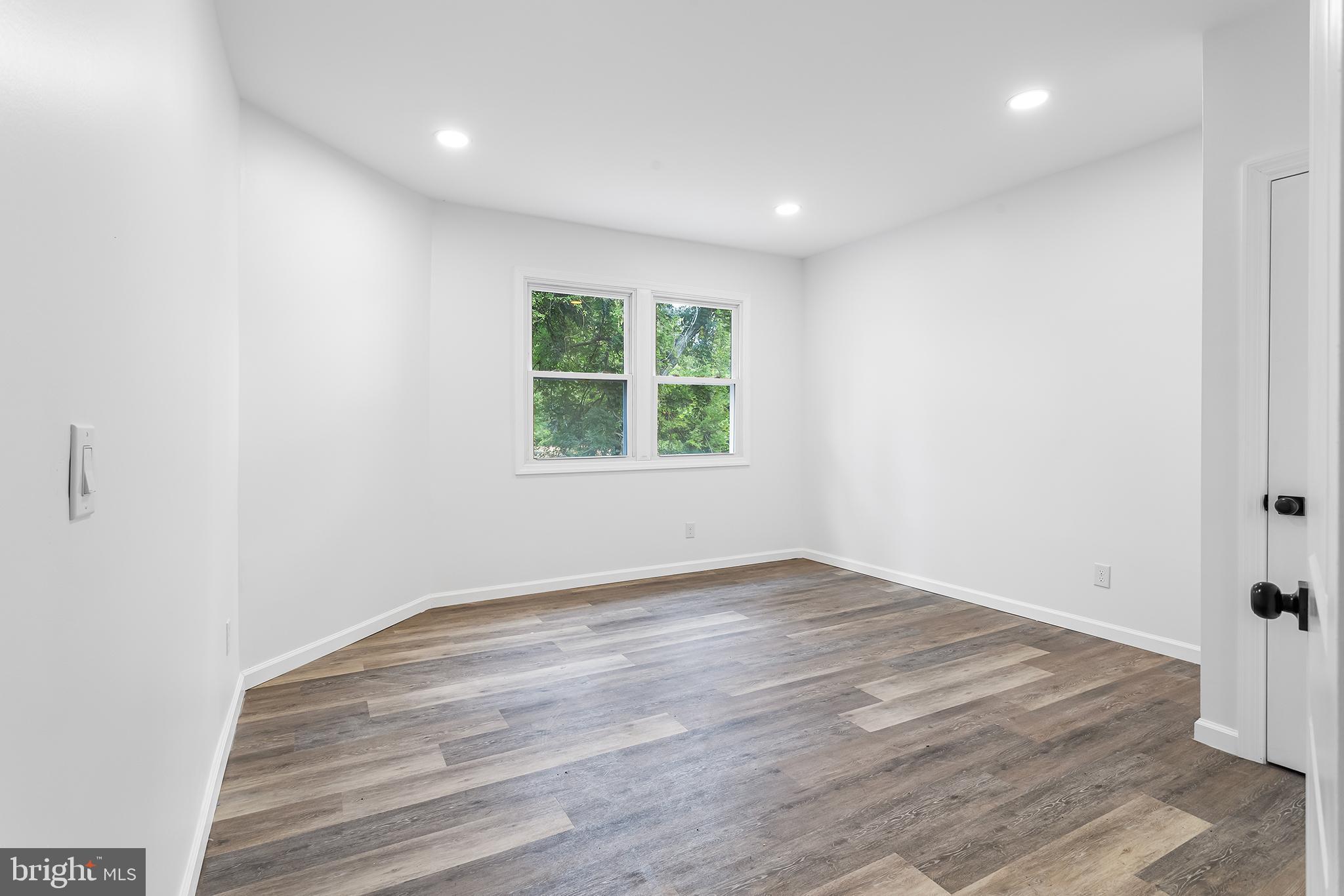 97 Erial Road Clementon, NJ 08021 - Photo 17 of 48 an empty room with wooden floor and windows