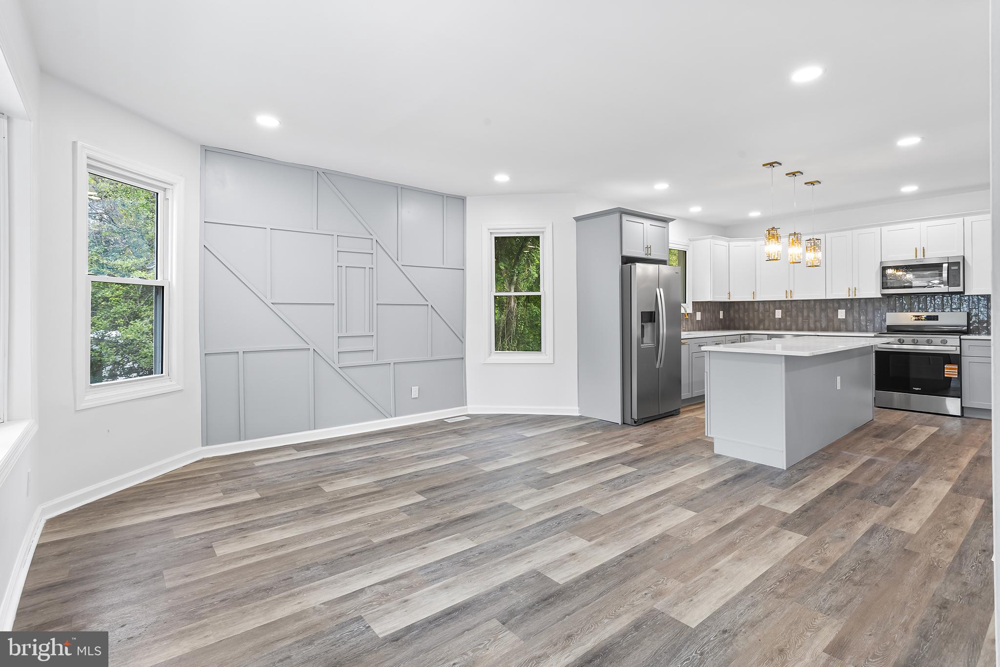 97 Erial Road Clementon, NJ 08021 - Photo 9 of 48 a view of kitchen with kitchen island a sink wooden floor and a refrigerator