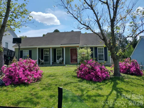 a front view of a house with a garden and porch