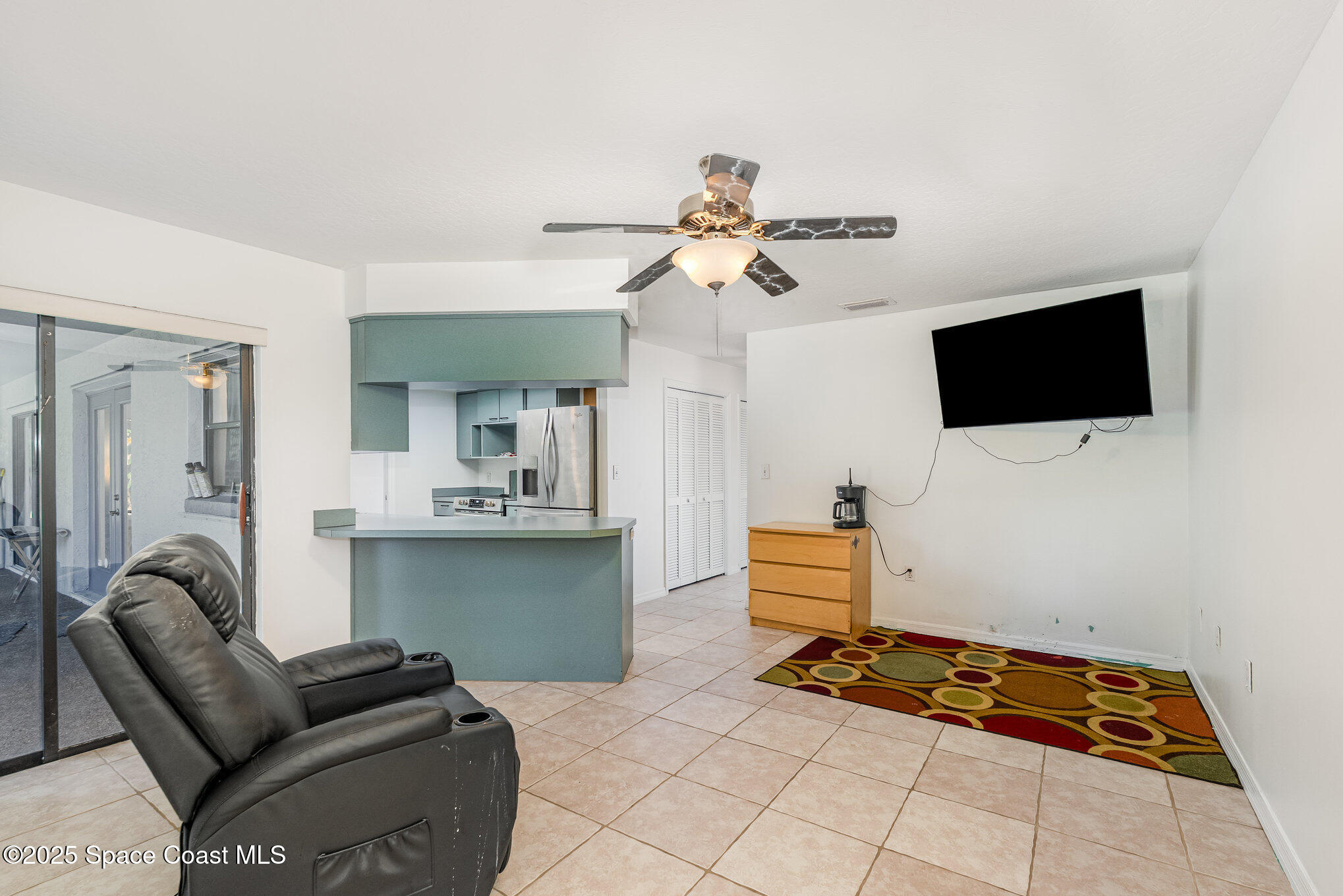 5720 Flint Road Cocoa, FL 32927 - Photo 15 of 26 a living room with furniture and a flat screen tv