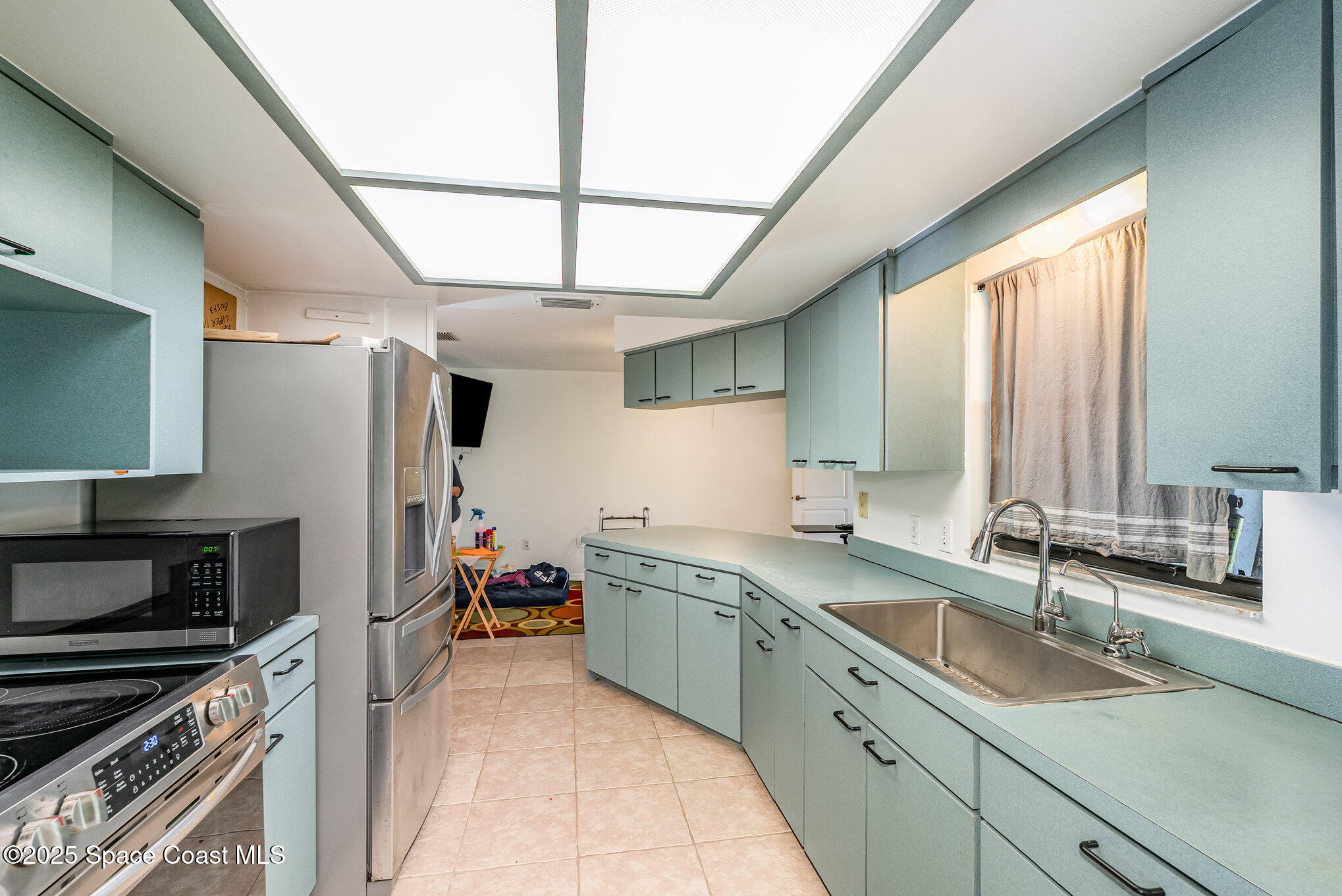 5720 Flint Road Cocoa, FL 32927 - Photo 17 of 26 a kitchen with a sink stove and cabinets