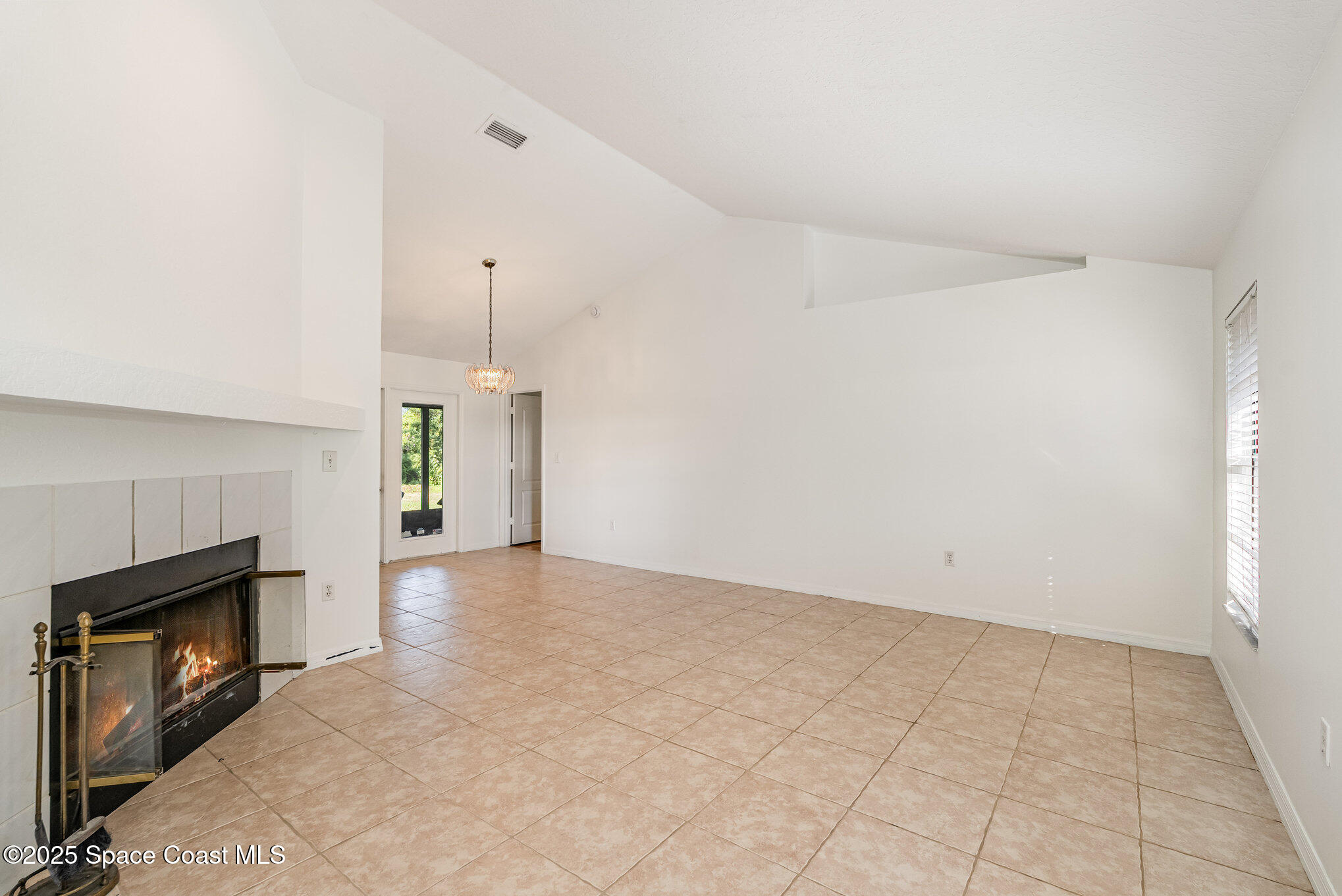 5720 Flint Road Cocoa, FL 32927 - Photo 22 of 26 a view of an empty room with window and fireplace