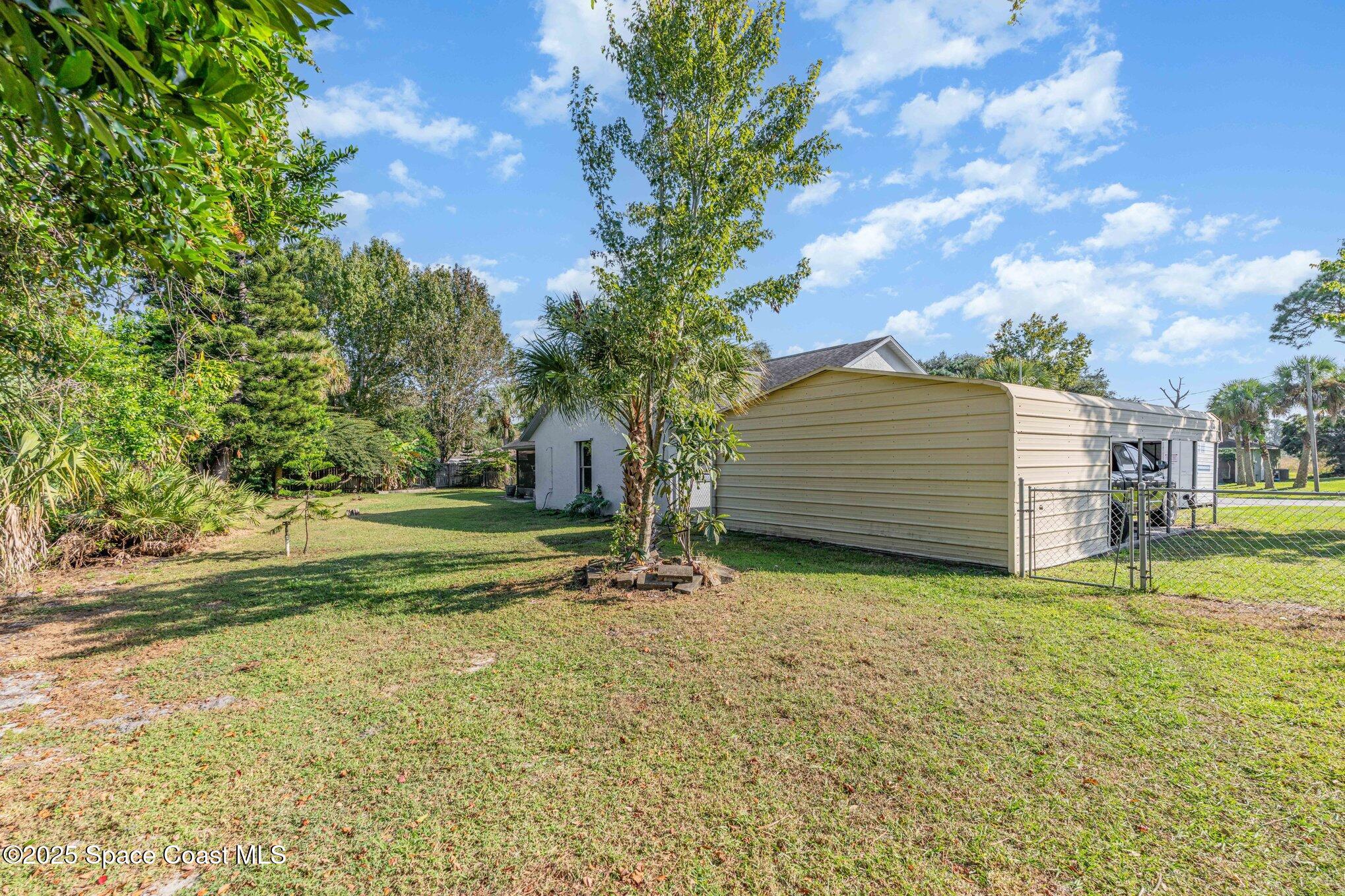 5720 Flint Road Cocoa, FL 32927 - Photo 25 of 26 a view of a backyard with large trees