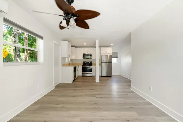 a kitchen with a refrigerator a microwave and cabinets