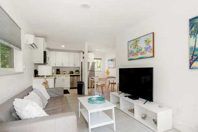 a kitchen with stainless steel appliances granite countertop grey cabinets a stove a sink and dishwasher