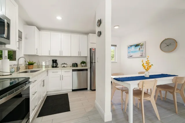 a kitchen with a refrigerator and a stove top oven