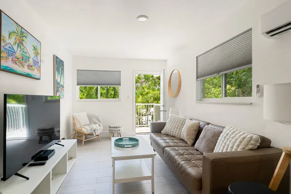 a kitchen with stainless steel appliances granite countertop white cabinets a sink and a stove