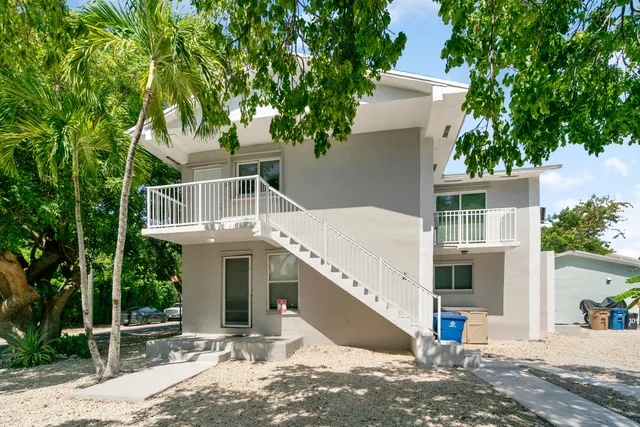 a kitchen with granite countertop a refrigerator and a stove top oven