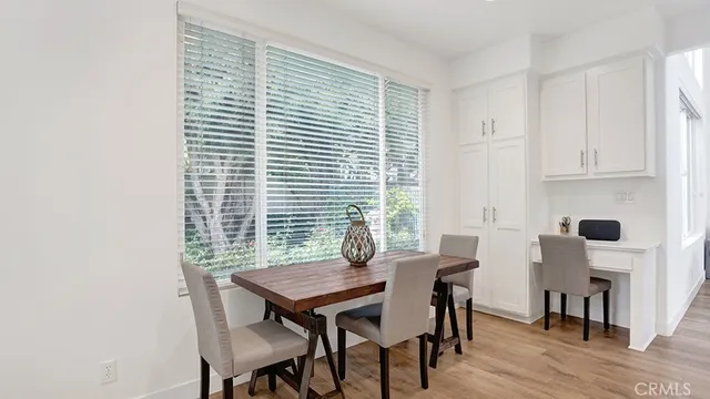 a living room with furniture a fireplace and a large window