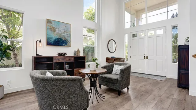 a living room with furniture a window and a painting on the wall