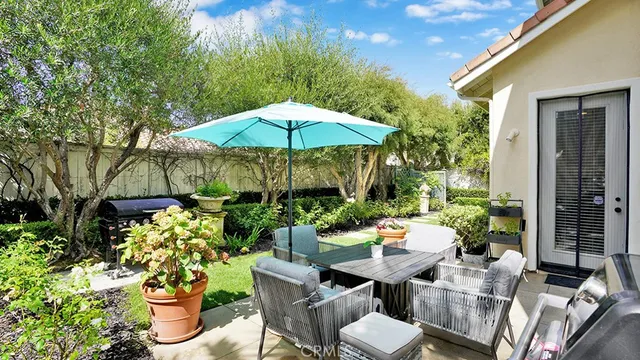 an aerial view of residential houses with outdoor space and trees all around