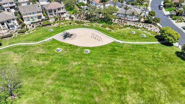 a view of a house with snow on the road and a building