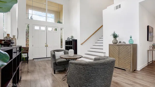 a living room with furniture a fireplace and wooden floor