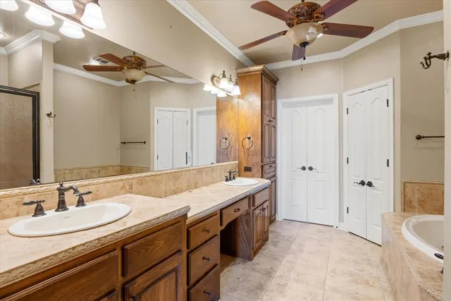 a bathroom with a granite countertop sink mirror and a bathtub