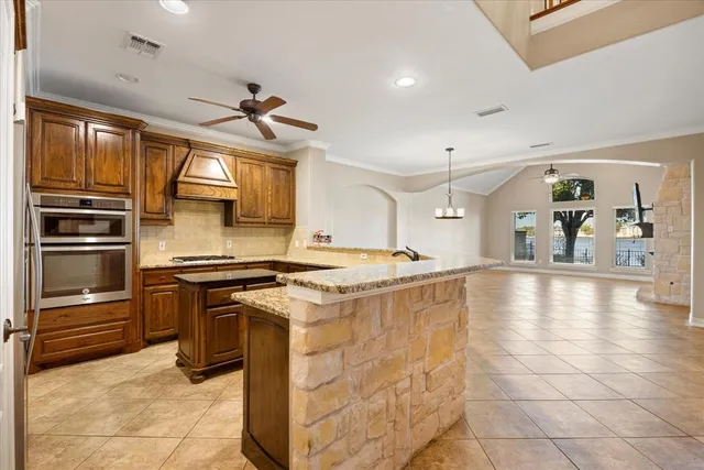 a kitchen with stainless steel appliances granite countertop a stove and a refrigerator