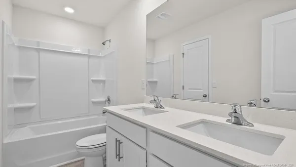 a bathroom with 2 sink and a mirror